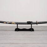 Katana sword on the wooden floor background front view.